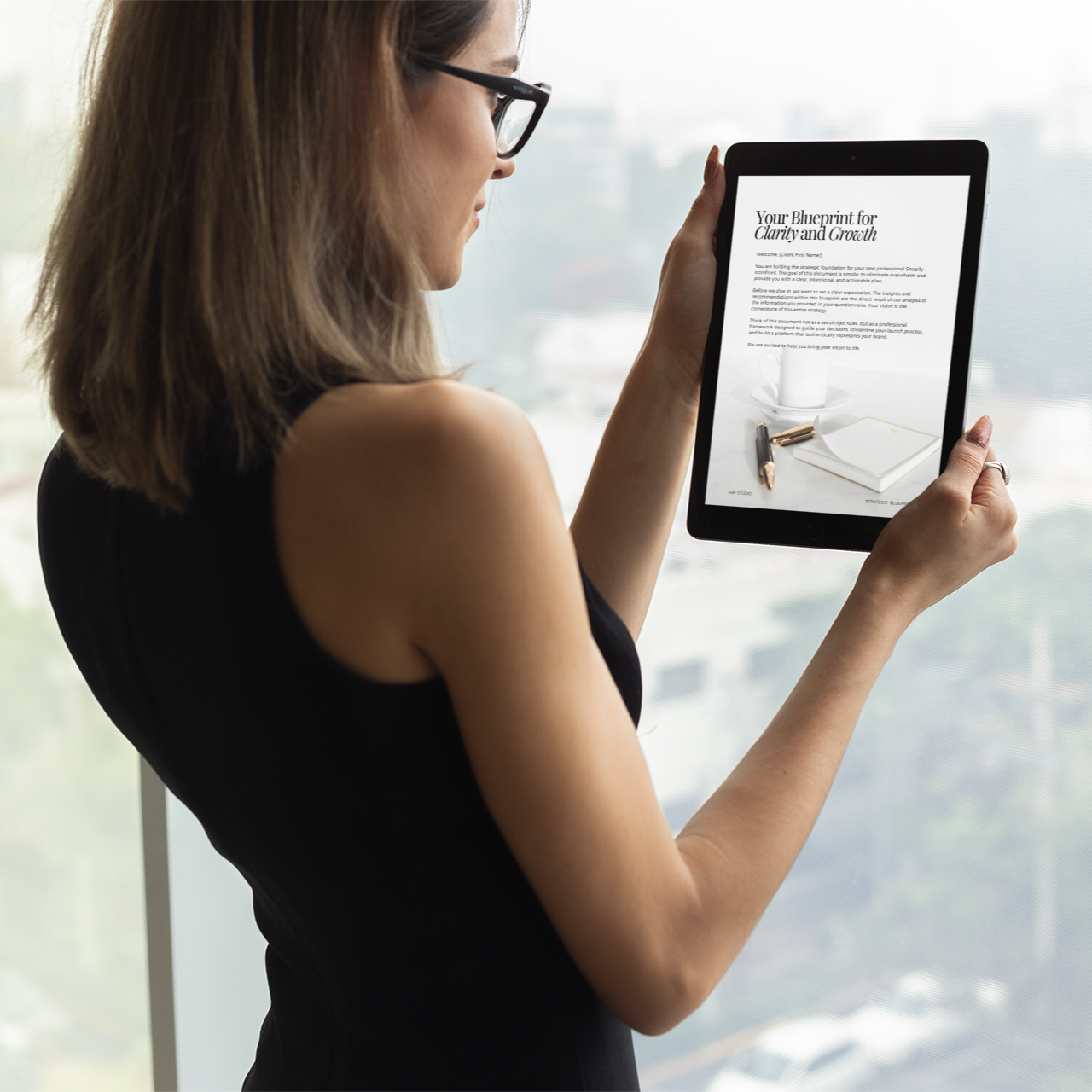 Woman holding a tablet with a blurred background