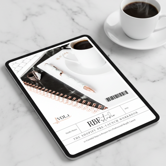 Tablet displaying RBF Studio Shopify Pre-Launch Checklist on a marble surface with a cup of coffee.